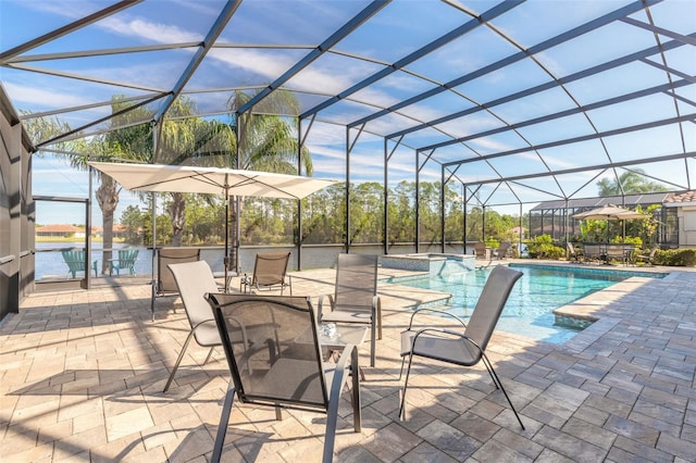 view of swimming pool with glass enclosure, a patio area, and a water view