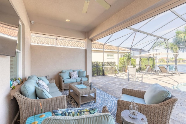 view of patio / terrace featuring glass enclosure, ceiling fan, and an outdoor hangout area