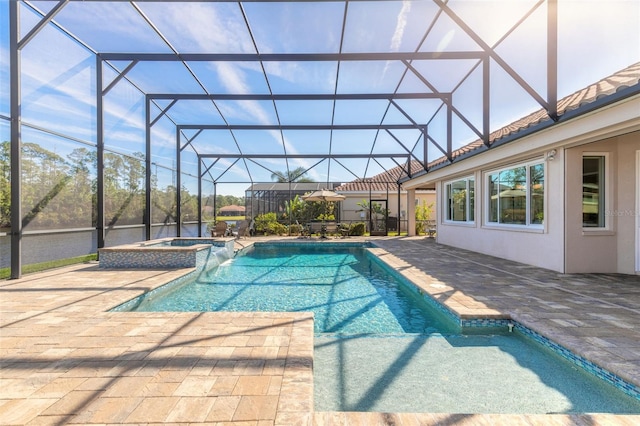 view of pool featuring glass enclosure, an in ground hot tub, and a patio