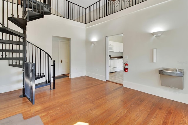 entryway with a towering ceiling and hardwood / wood-style flooring