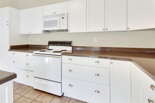 kitchen featuring white cabinets, white appliances, and light tile patterned flooring