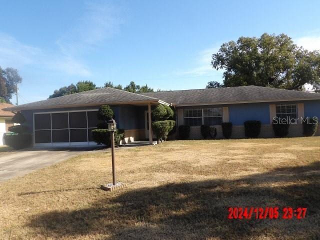 ranch-style home with a front lawn