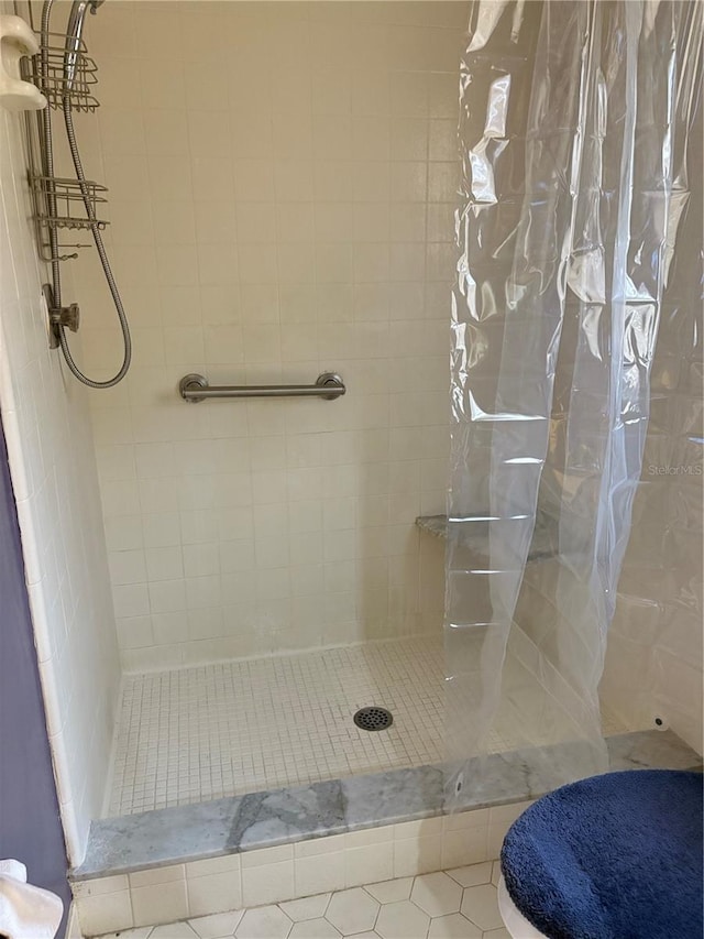 bathroom with tile patterned flooring and a shower with shower curtain