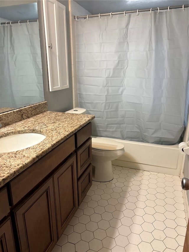 full bathroom featuring tile patterned flooring, vanity, shower / bath combination with curtain, and toilet