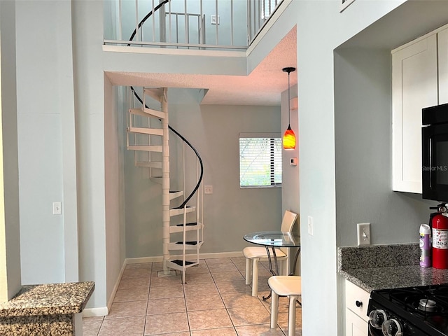 stairs featuring a textured ceiling and tile patterned floors