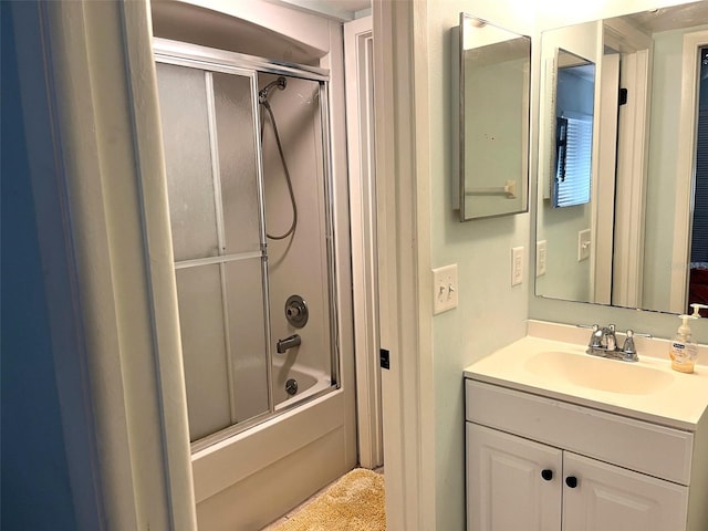 bathroom featuring vanity and bath / shower combo with glass door