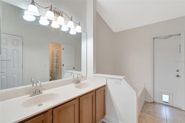 bathroom featuring vanity, a bath, vaulted ceiling, tile patterned flooring, and toilet