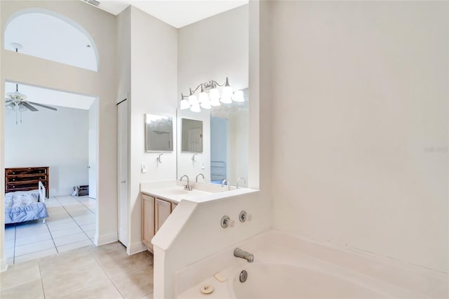 bathroom featuring vanity, a high ceiling, tile patterned floors, ceiling fan, and a tub