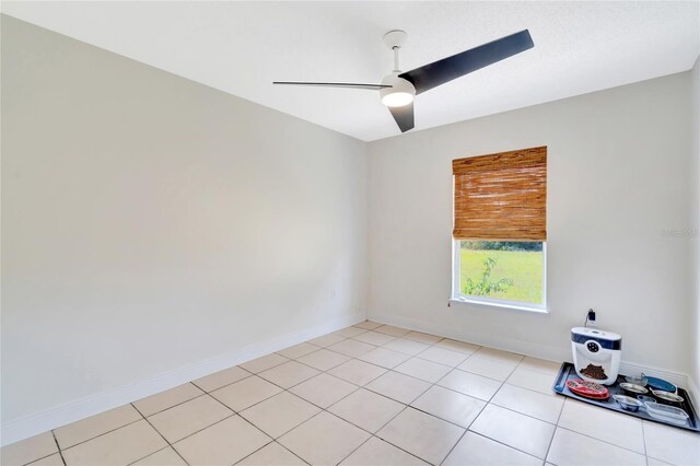 spare room with light tile patterned floors and ceiling fan