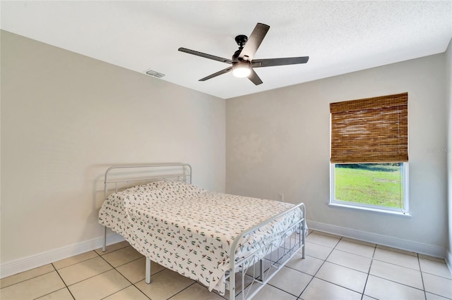 bedroom featuring ceiling fan and light tile patterned flooring