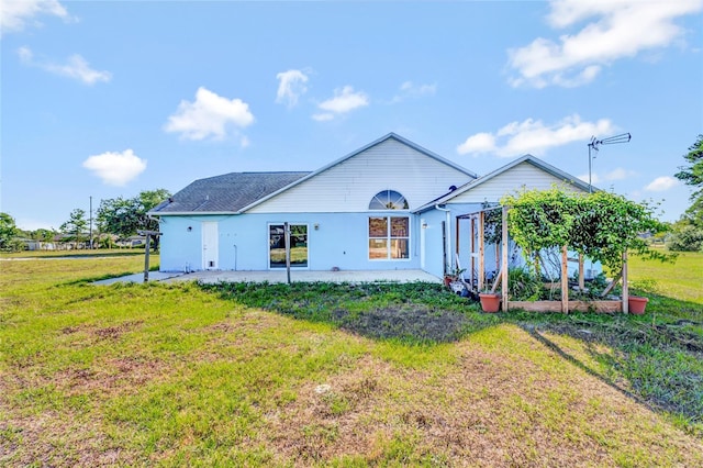 back of property featuring a lawn and a patio area