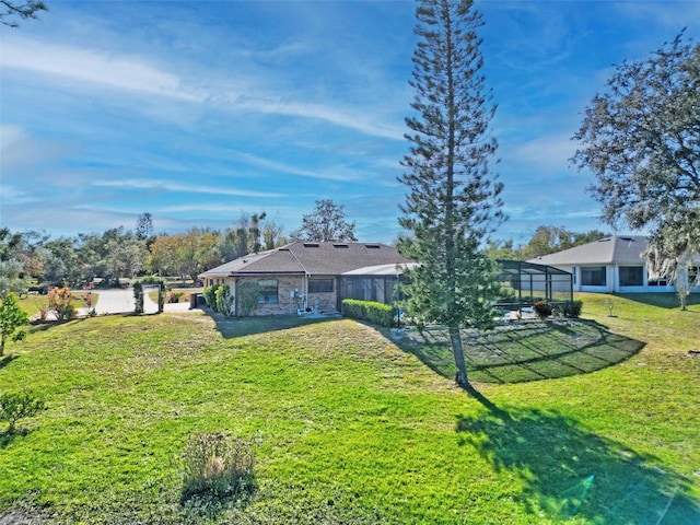 view of yard featuring glass enclosure