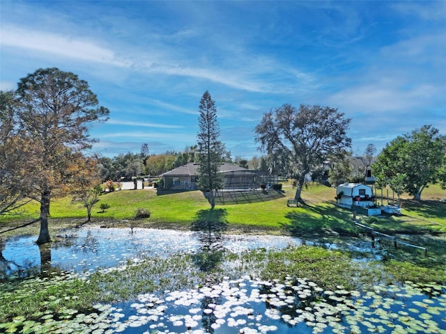 surrounding community featuring a yard and a water view