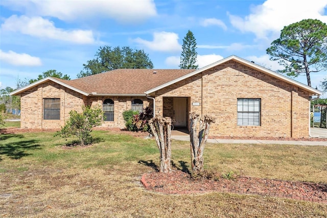 ranch-style home featuring a front yard