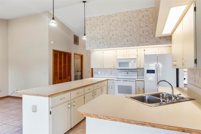 kitchen featuring sink, a kitchen island, pendant lighting, white appliances, and light tile patterned flooring