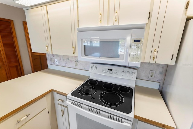 kitchen featuring white cabinets, decorative backsplash, and white appliances