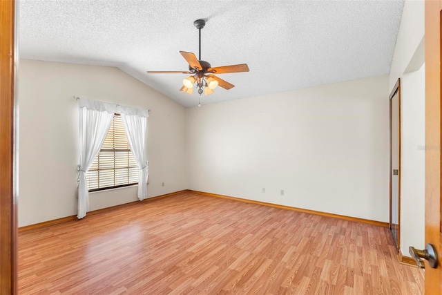 unfurnished room featuring a textured ceiling, ceiling fan, light hardwood / wood-style floors, and lofted ceiling