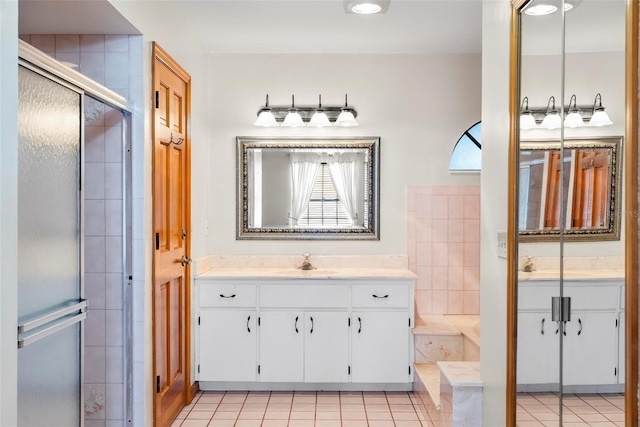 bathroom featuring tile patterned flooring, vanity, and plus walk in shower