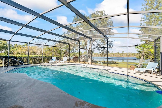 view of swimming pool featuring a lanai, a patio area, and a water view