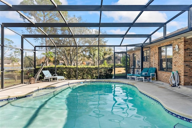 view of swimming pool with glass enclosure and a patio