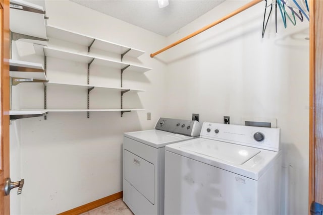 laundry room with washing machine and dryer and a textured ceiling