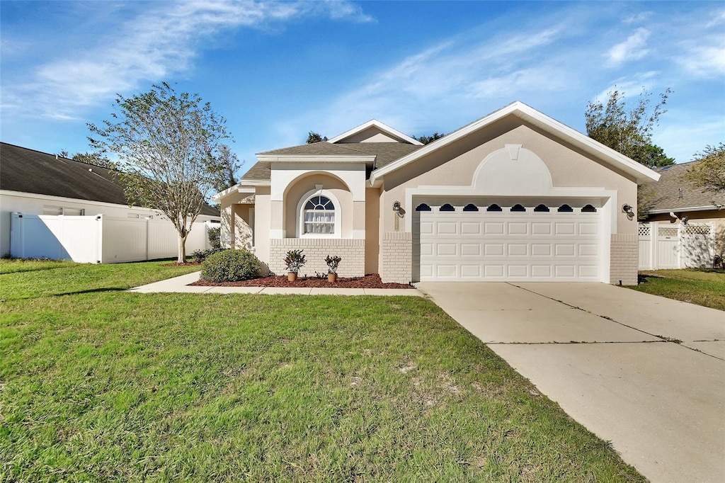 view of front of home featuring a garage and a front lawn