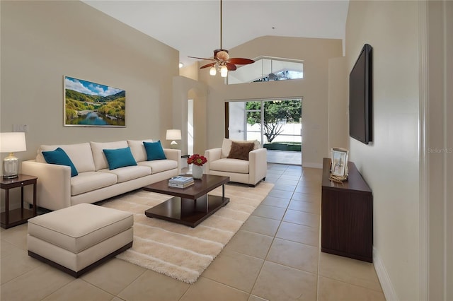 tiled living room with ceiling fan and high vaulted ceiling