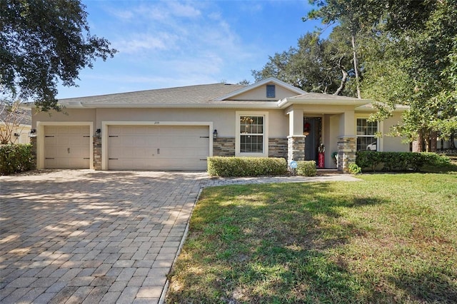 view of front of home featuring a front yard and a garage