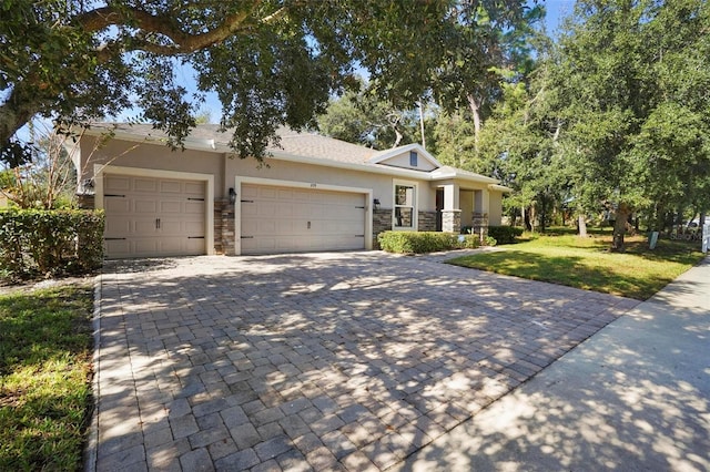 view of front of property with a front yard and a garage