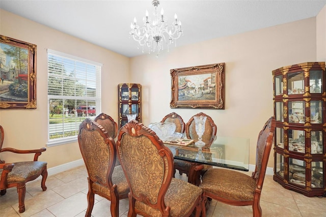 dining space with a chandelier and light tile patterned flooring