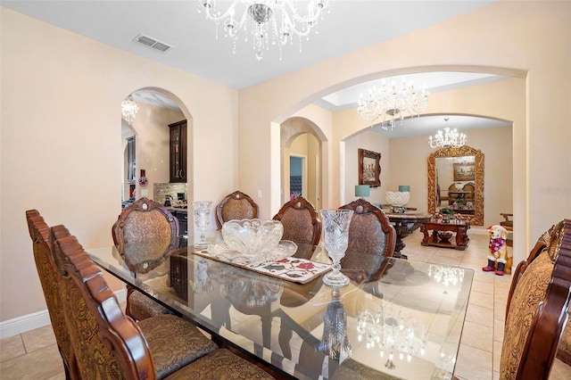 dining room featuring light tile patterned floors and an inviting chandelier