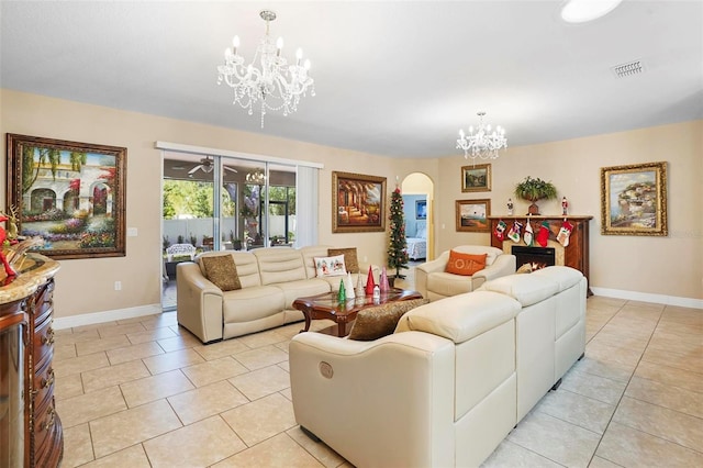 tiled living room with a notable chandelier