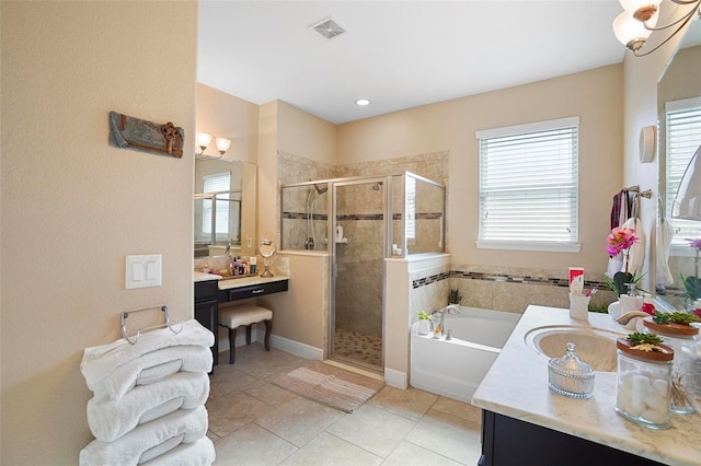 bathroom with tile patterned flooring, vanity, plus walk in shower, and a wealth of natural light