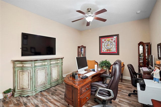 home office featuring hardwood / wood-style floors and ceiling fan