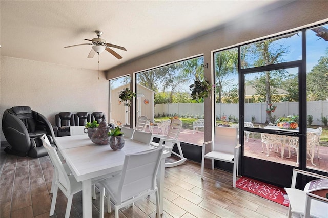 sunroom featuring ceiling fan