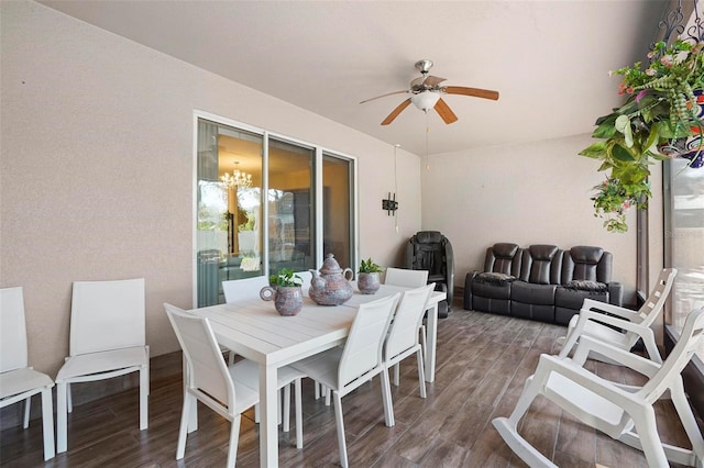 dining area featuring hardwood / wood-style floors and ceiling fan with notable chandelier