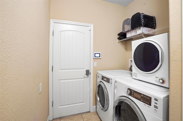 laundry area with washer and dryer and light tile patterned flooring