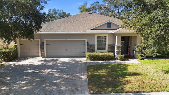 view of front of house featuring a garage and a front lawn