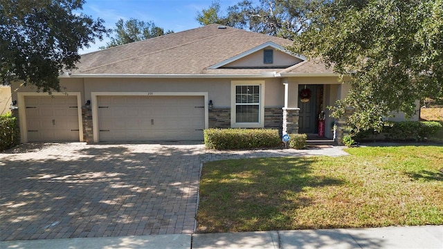 view of front of house with a front yard and a garage