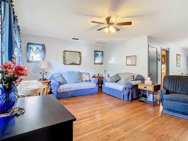 living room with ceiling fan and light wood-type flooring