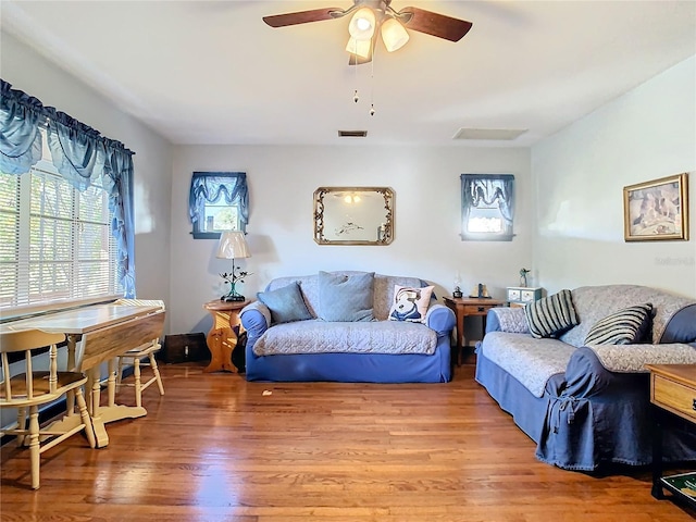 living room with ceiling fan and wood-type flooring