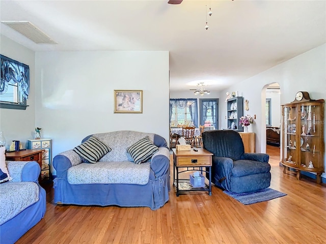 living room with hardwood / wood-style flooring and ceiling fan