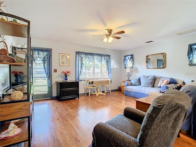 living room featuring light wood-type flooring and ceiling fan