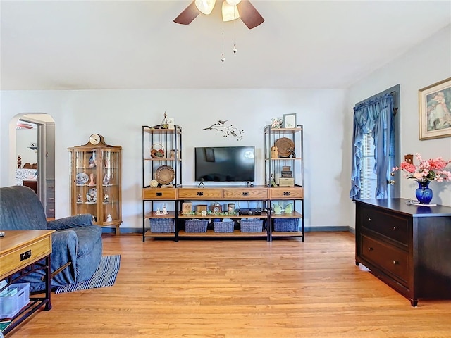 living room featuring ceiling fan and light hardwood / wood-style floors