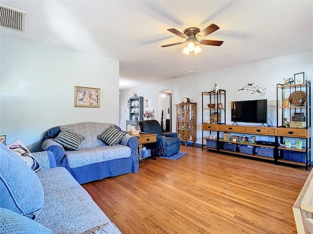 living room featuring hardwood / wood-style floors and ceiling fan