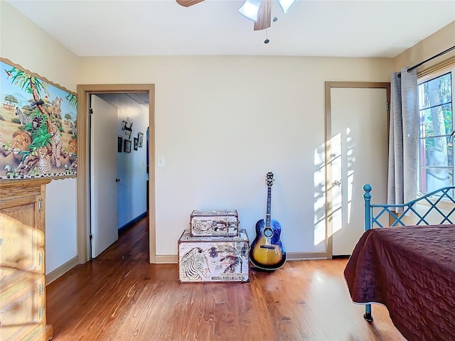 bedroom with ceiling fan and wood-type flooring