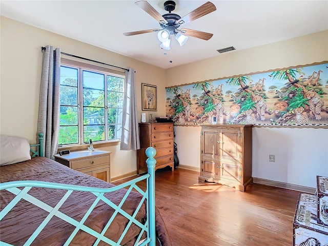 bedroom featuring ceiling fan and dark hardwood / wood-style flooring