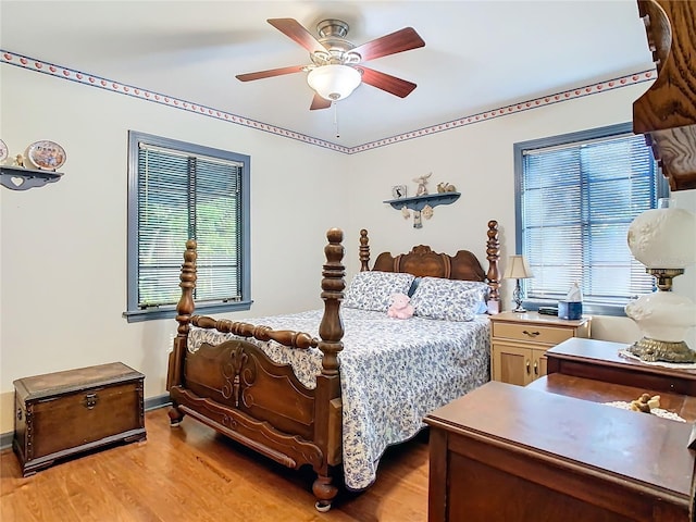 bedroom with ceiling fan and light hardwood / wood-style flooring