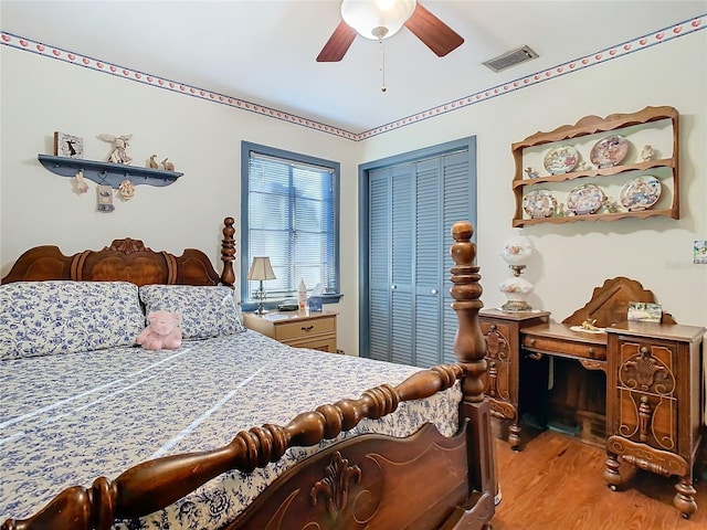 bedroom with hardwood / wood-style flooring, ceiling fan, and a closet