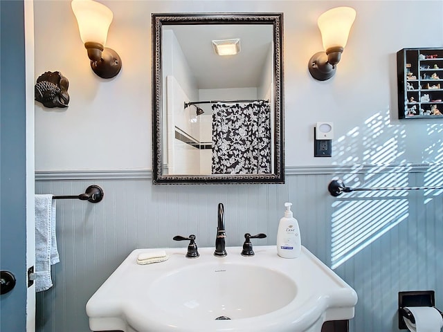 bathroom featuring walk in shower and sink